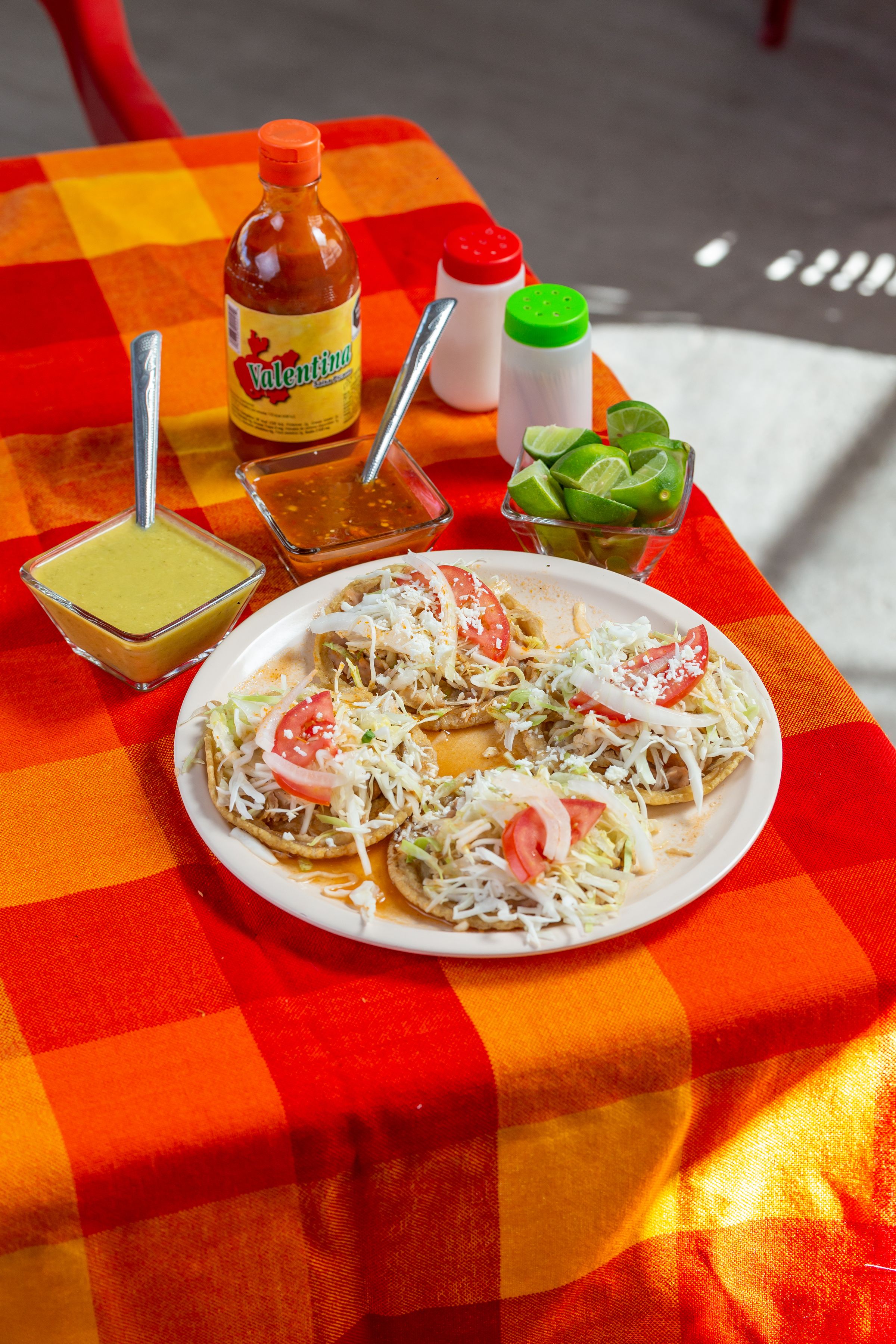 Colorful tacos served with lime and salsa